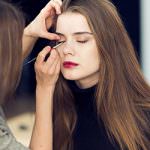 A brunette lady getting her eyelashes worked on by a beauty therapist.